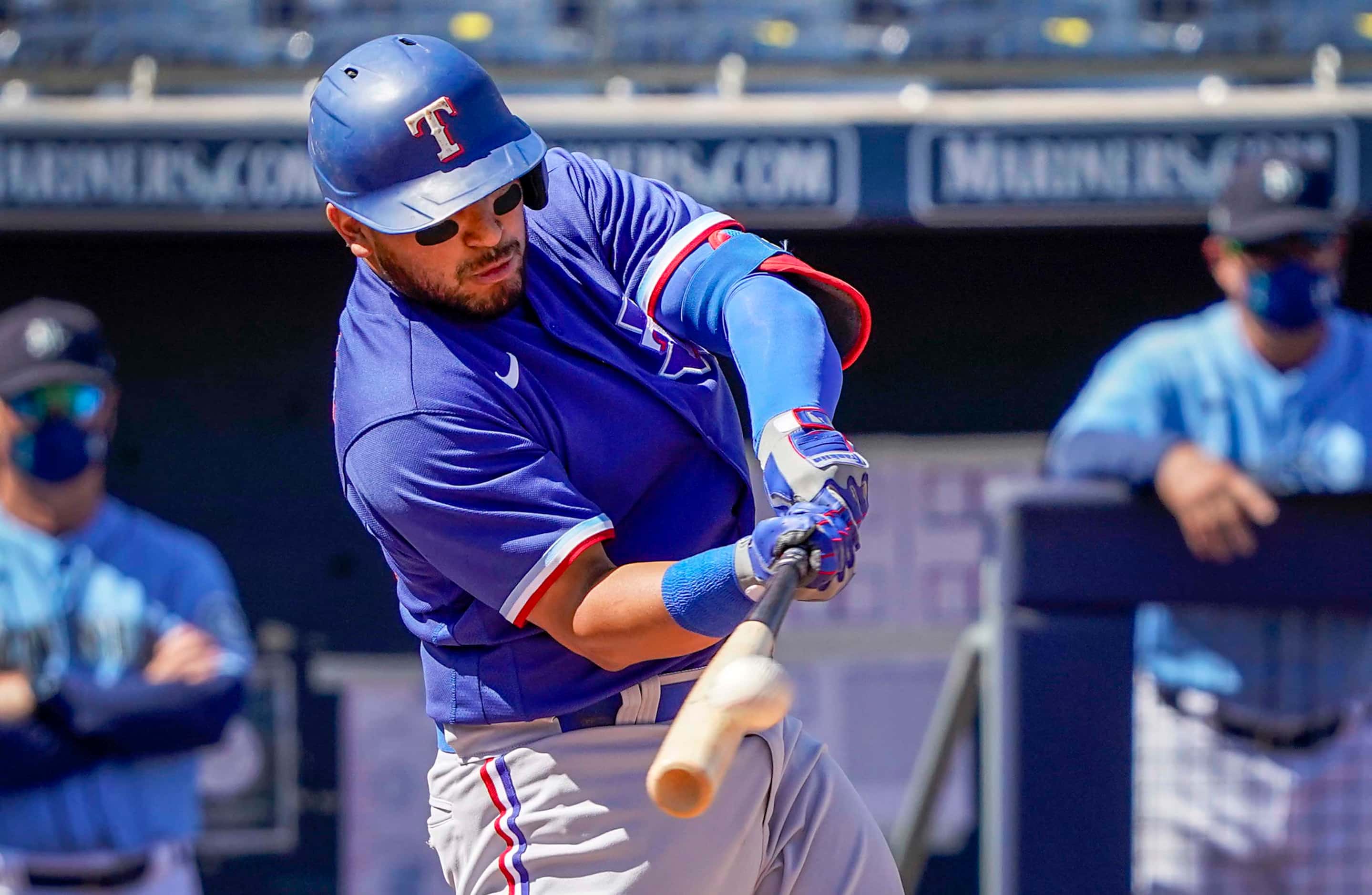 Texas Rangers catcher Jose Trevino hits a 2-run home run during the first inning of a spring...