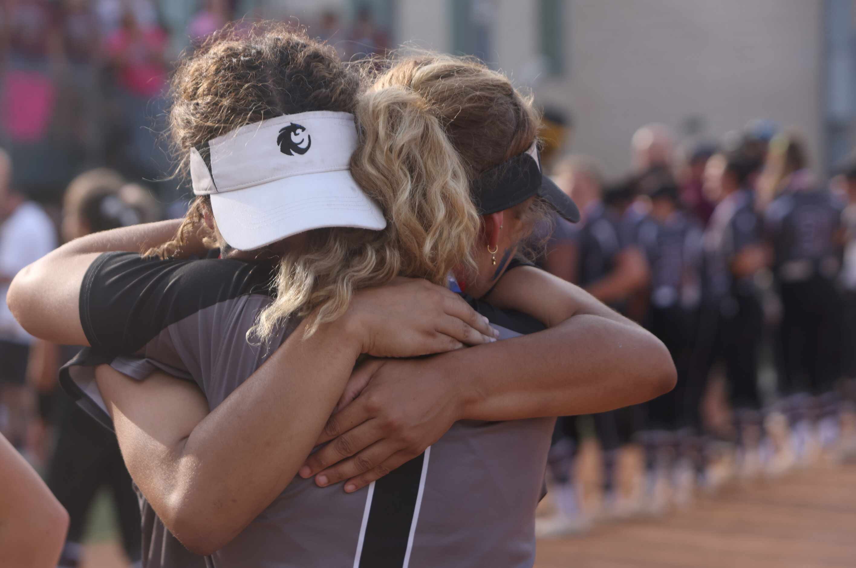 Avery Jefferson (1) and teammate Tehya Pitts (7) share a consoling hug following the team's...