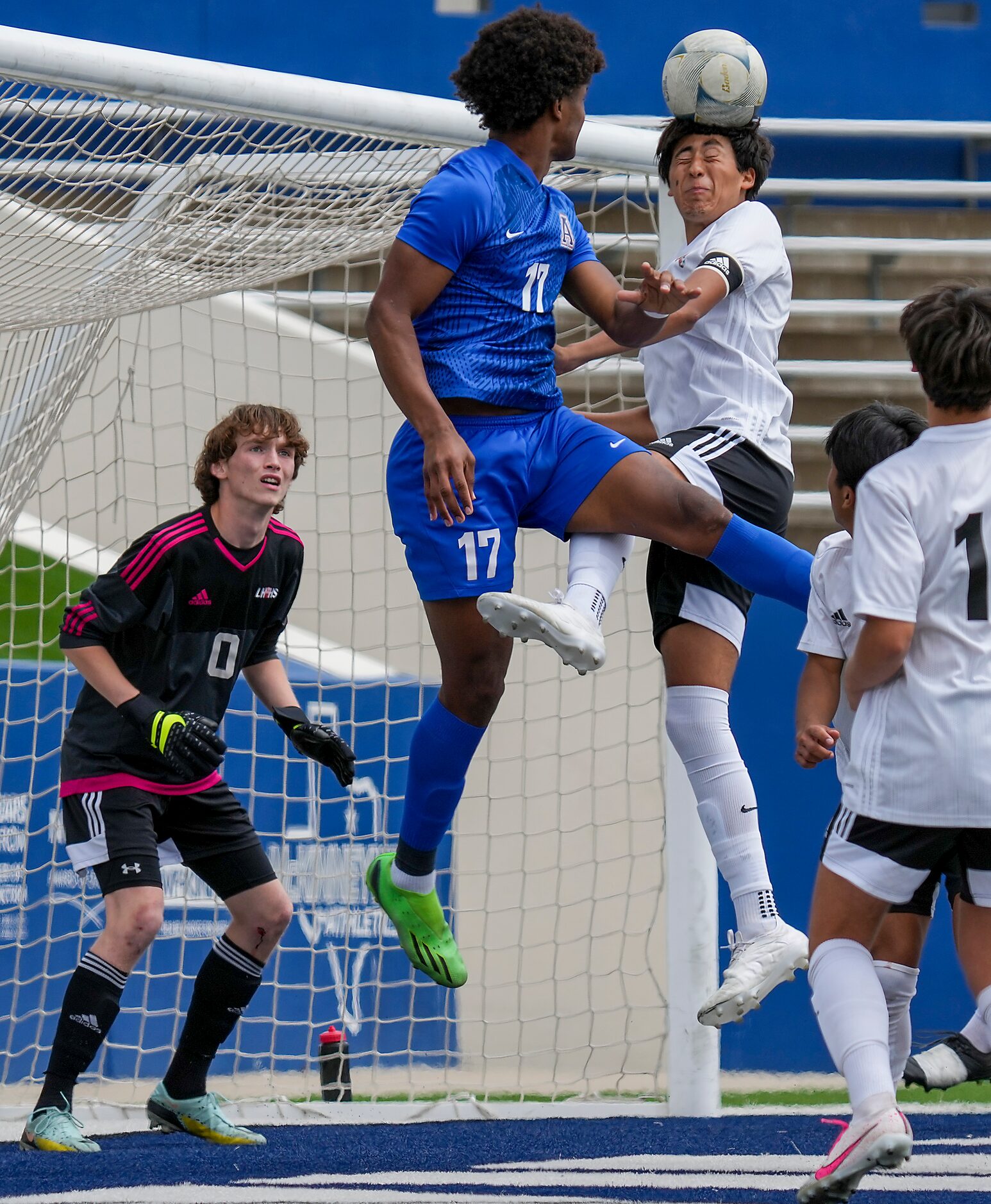 Lake Highlands defender Anthony Licea (5) head the ball away from goalkeeper Noah Smith (0)...