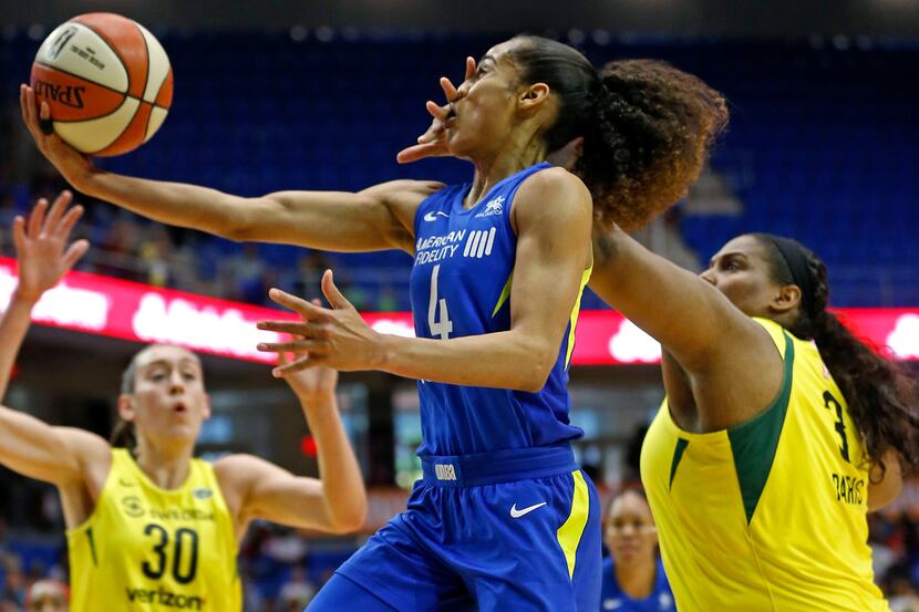 Dallas Wings guard Skylar Diggins-Smith (4) gets fouled by  Seattle Storm center Courtney...