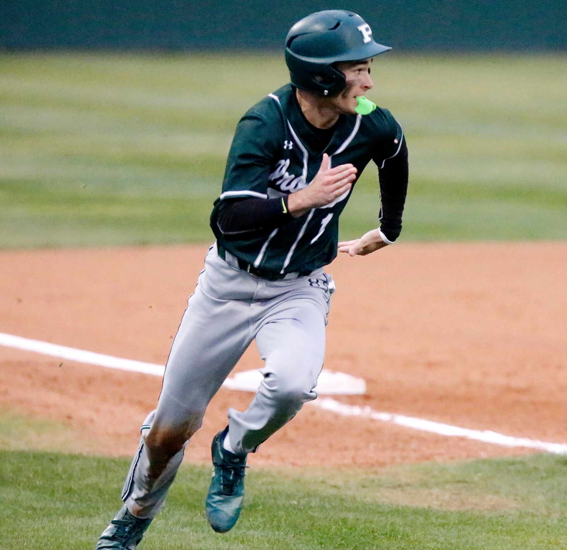 Prosper shortstop Chse Pendley (1) rounds third, going on to score the first run of the game...
