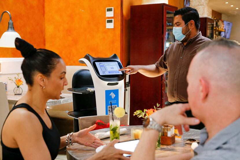 A server sends Panchita, a robot, back to the kitchen after she delivered food to customers...