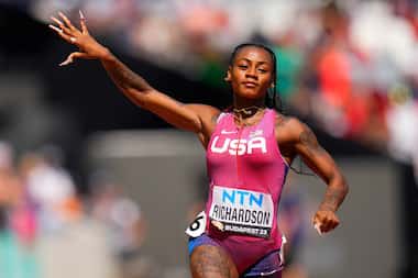Sha'Carri Richardson gestures after winning her 100 meters heat at the World Athletics...