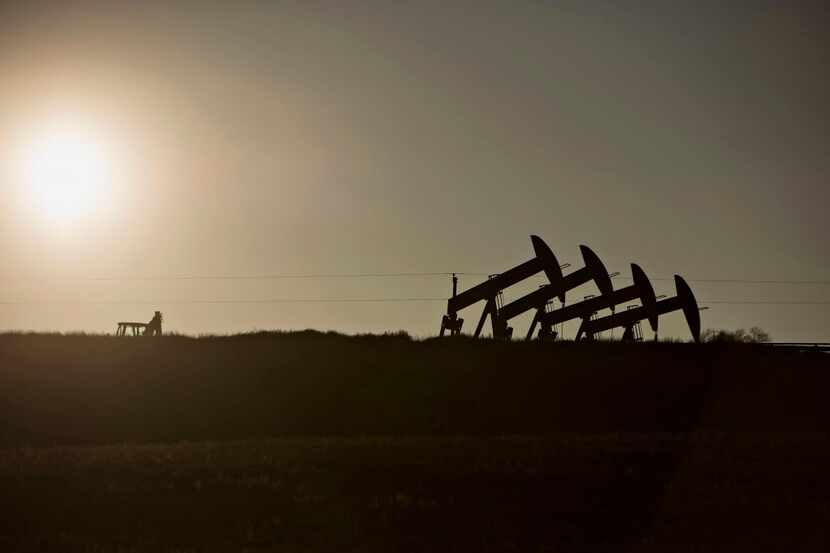 Four pumpjacks at the site of an oil well outside Williston, North Dakota, on Feb. 12, 2015....
