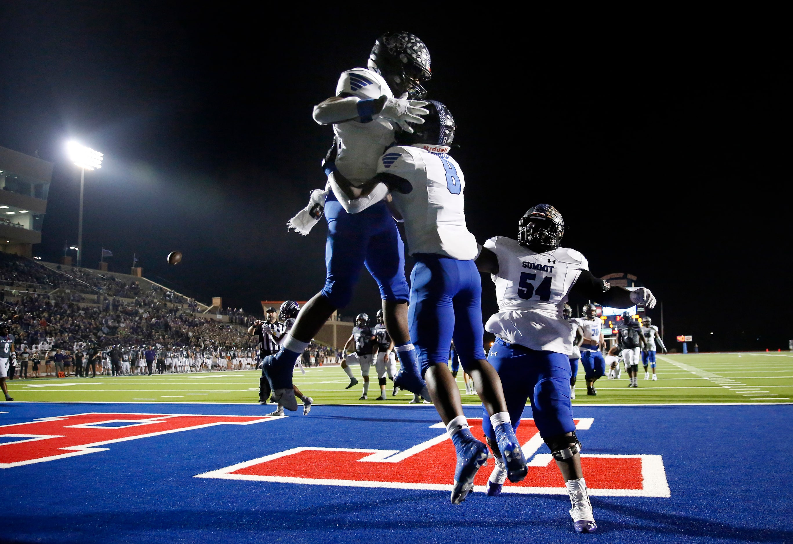 Mansfield Summit Keon Hobbs (8) is congratulated on his first half touchdown against College...