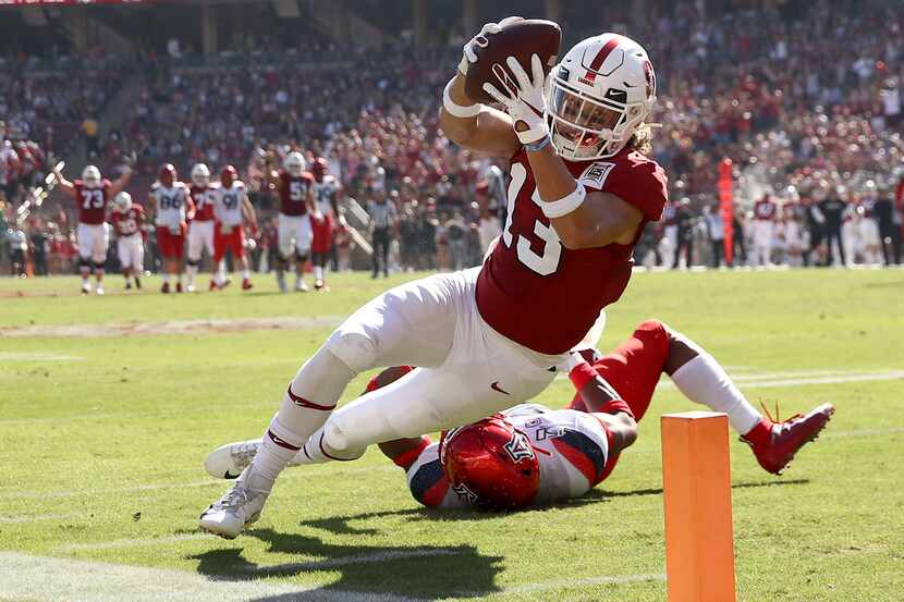 Simi Fehoko #13 of the Stanford Cardinal dives in the a touchdown after getting past Xavier...