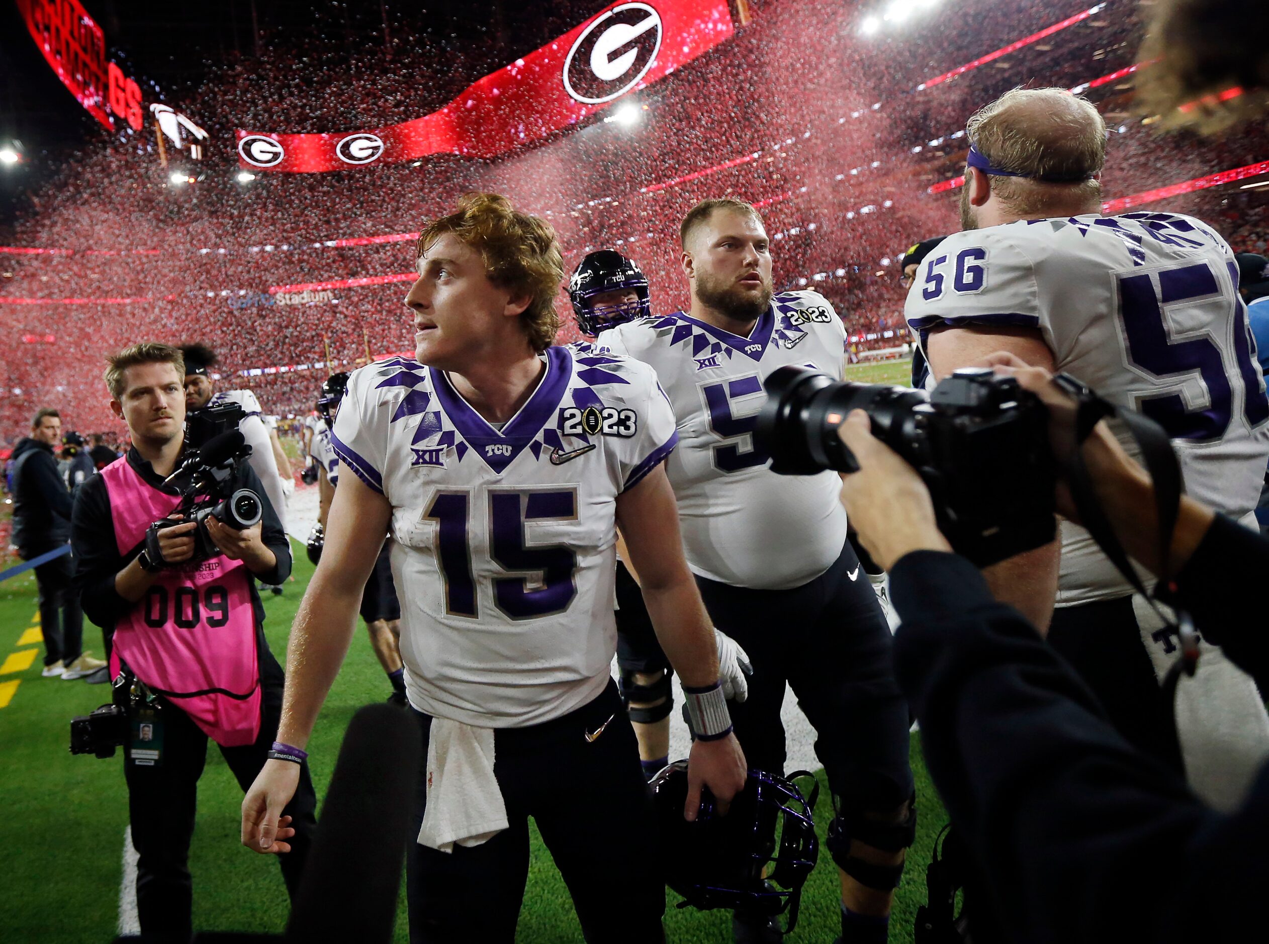 As Georgia Bulldogs red confetti rains down, TCU Horned Frogs quarterback Max Duggan (15)...