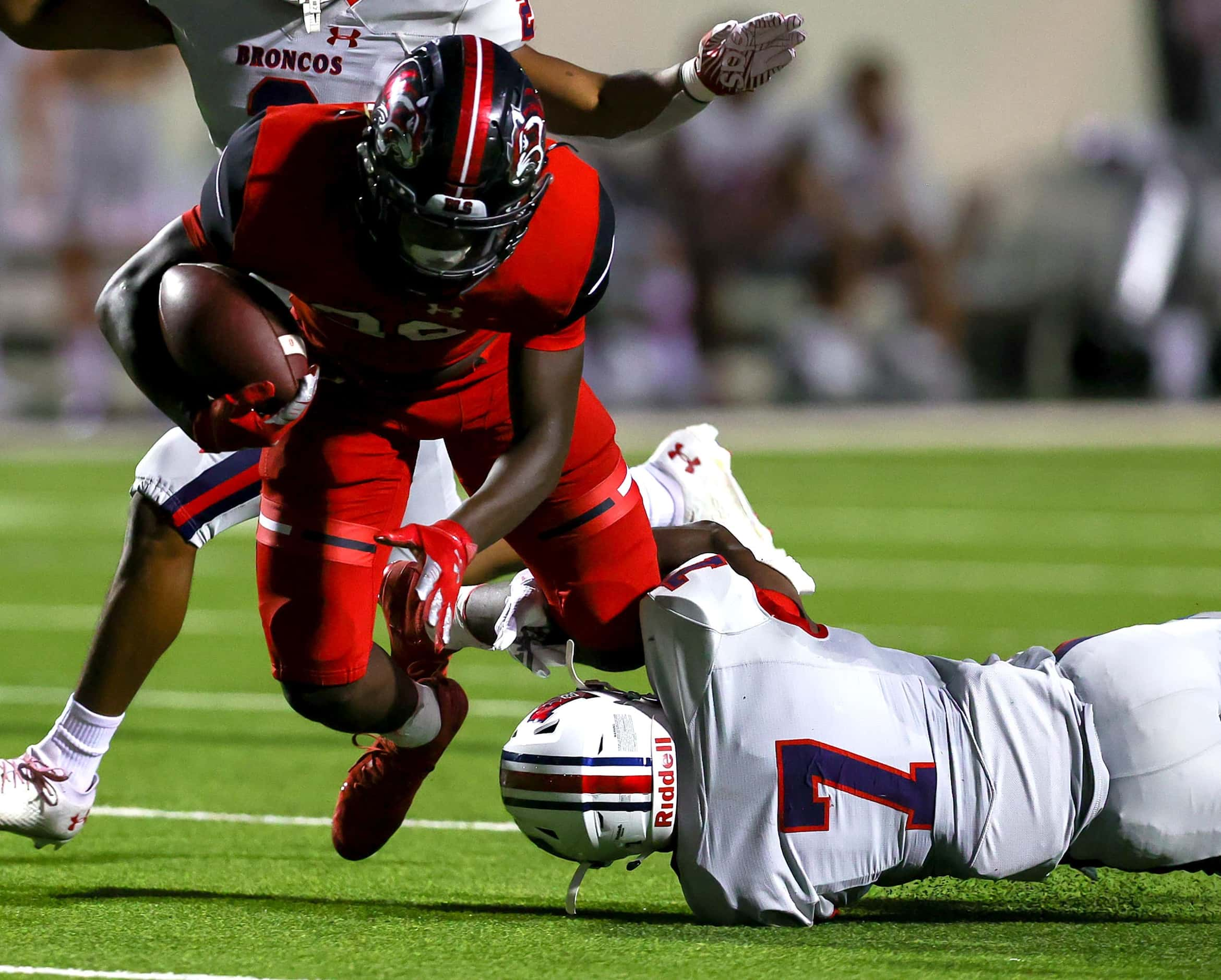 Denton Braswell running back Jaylon Burton (20) tries to break free from McKinney Boyd...