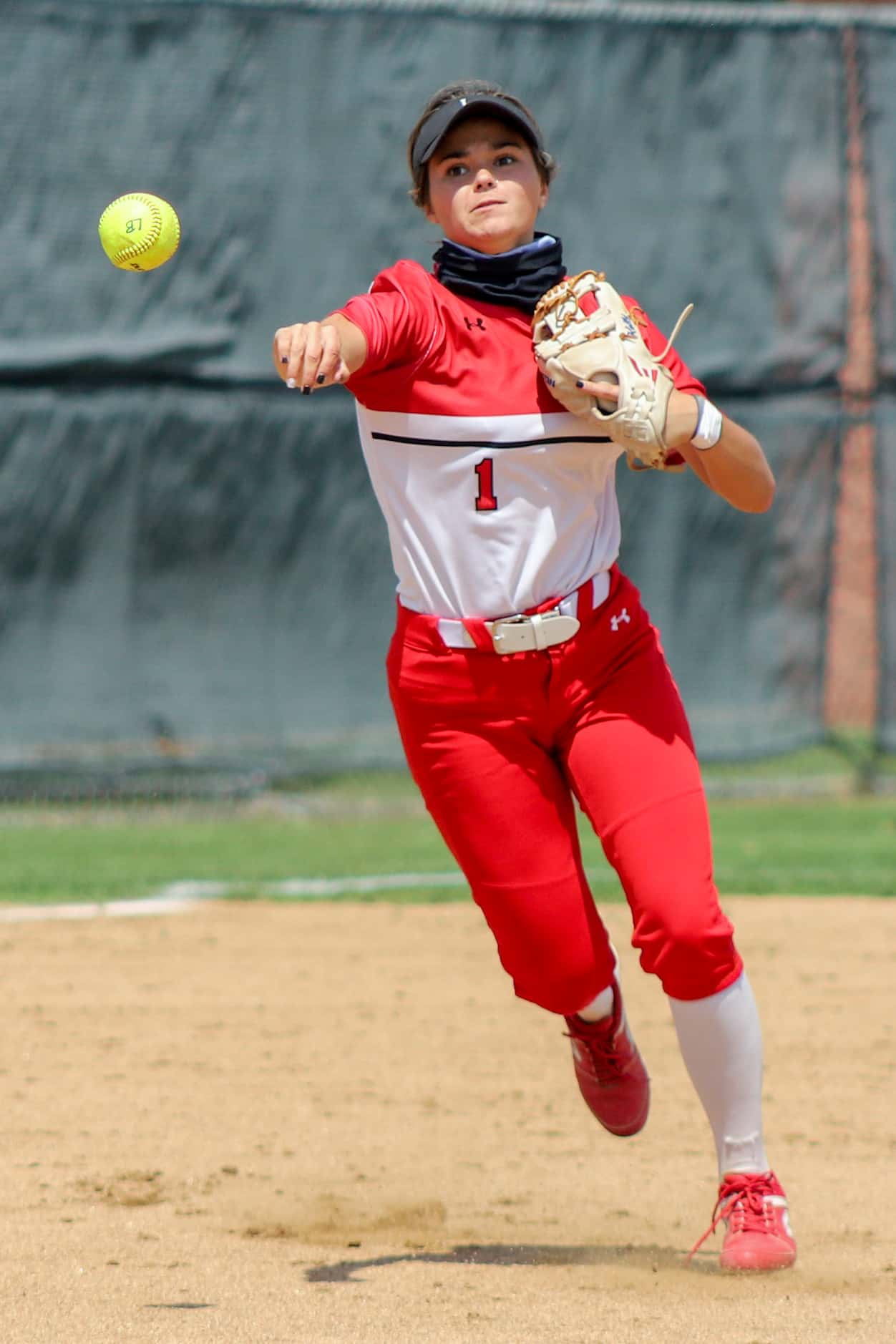 Mansfield Legacy third baseman Kelby Robbins (1) throws to first during a softball Class 5A...