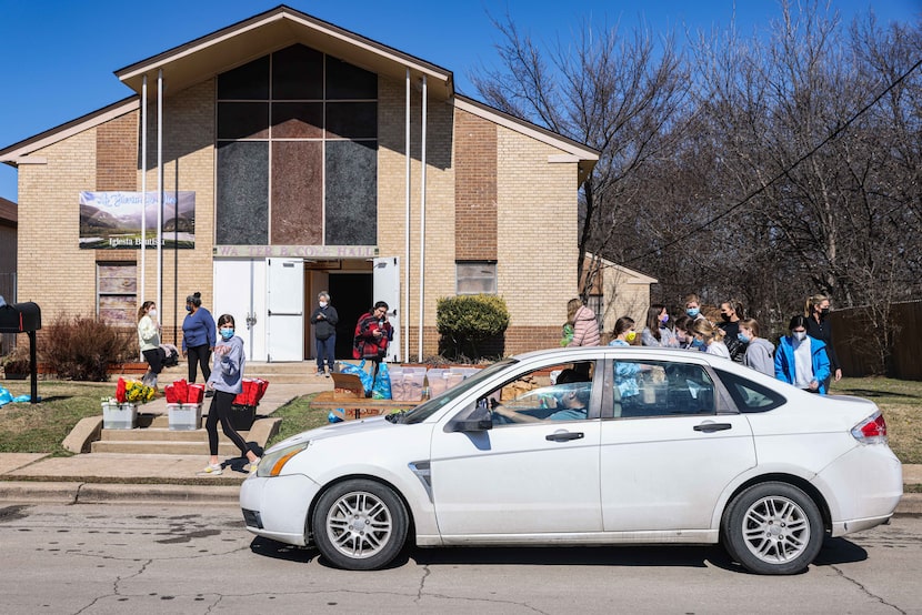 Volunteers distribute food to community members at Ledbetter Eagle Ford Community Pantry...