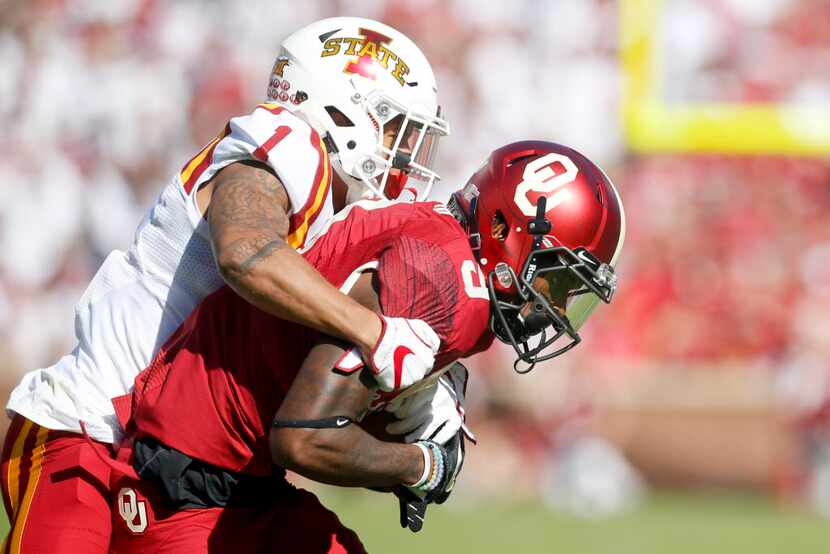 FILE - Iowa State defensive back D'Andre Payne (1) tackles Oklahoma wide receiver CeeDee...