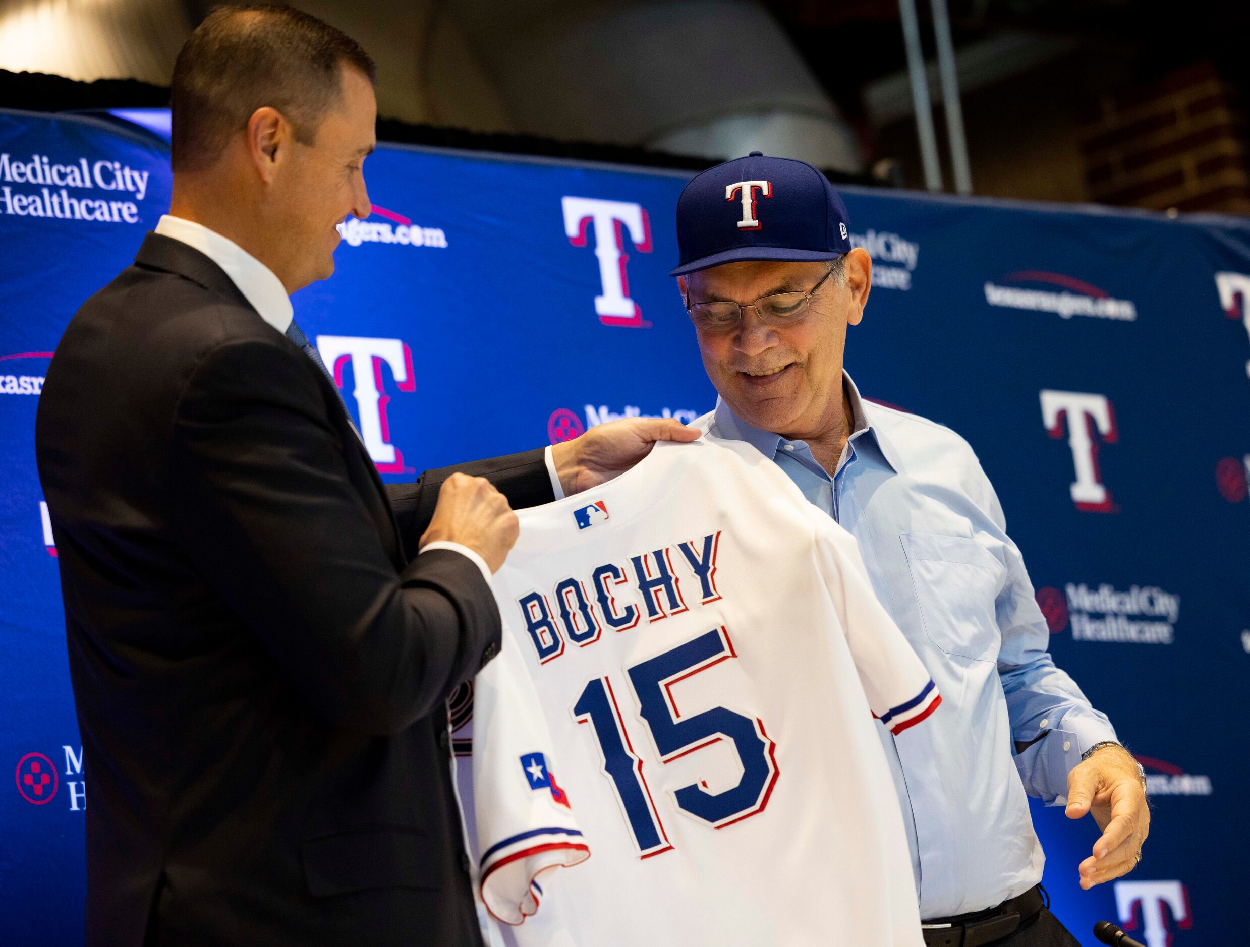 Chris Young (left), the team's executive vice president and general manager, gives new Texas...