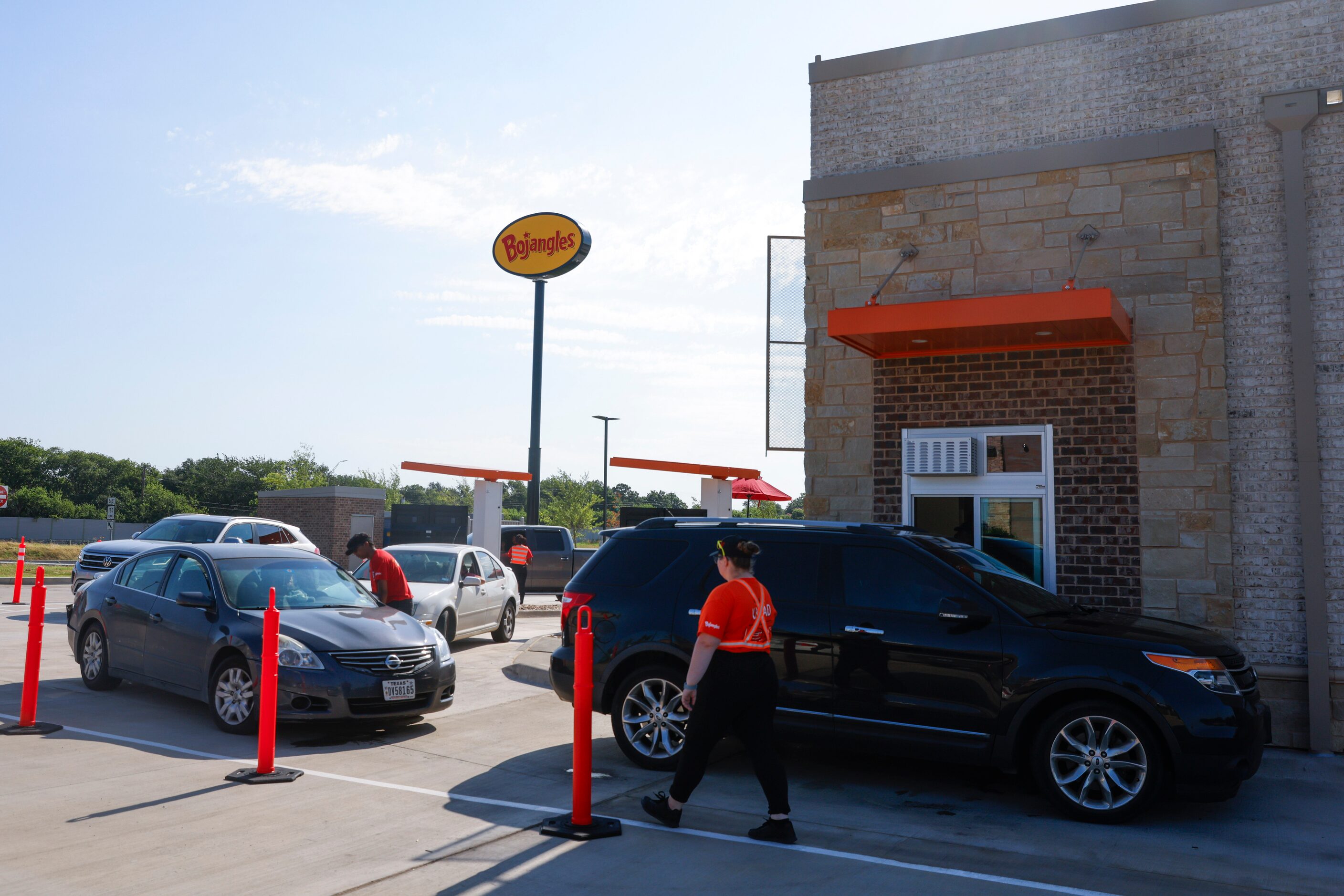 Cars line up for drive-through orders during the opening day of Bojangles in Euless on...