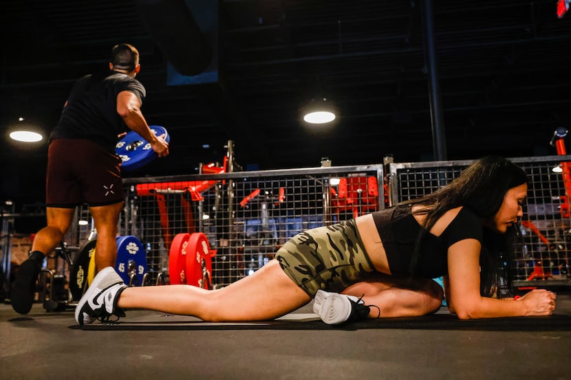 Member Mayra Espinoza, 34, trains at the Gold's Gym Highland Meadows in Dallas.