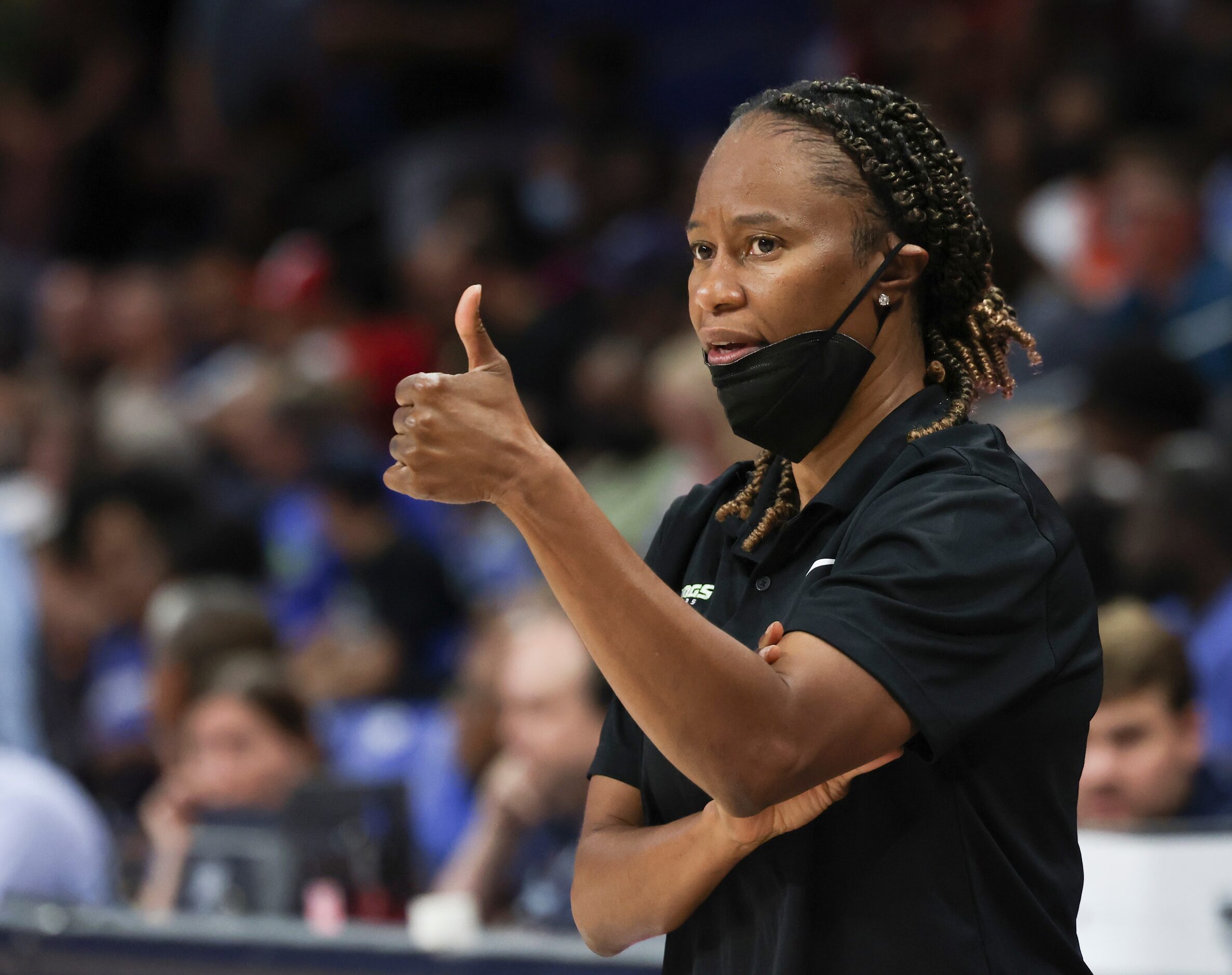 Vickie Johnson, Dallas Wings Head Coach, signals to players on the court during the game...