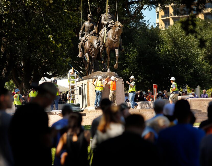 People gathered all afternoon to watch as crews from Howell Crane and Rigging Inc. tried to...