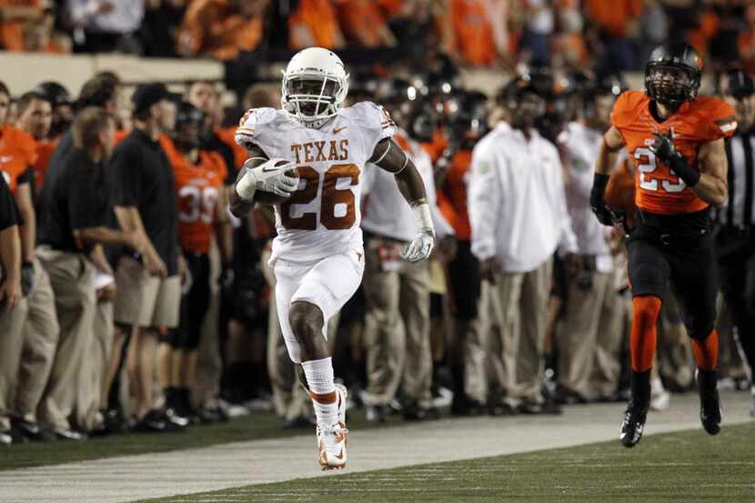 Texas player D.J. Monroe (26) returns a kick for 100 yards as Oklahoma State player Connor...