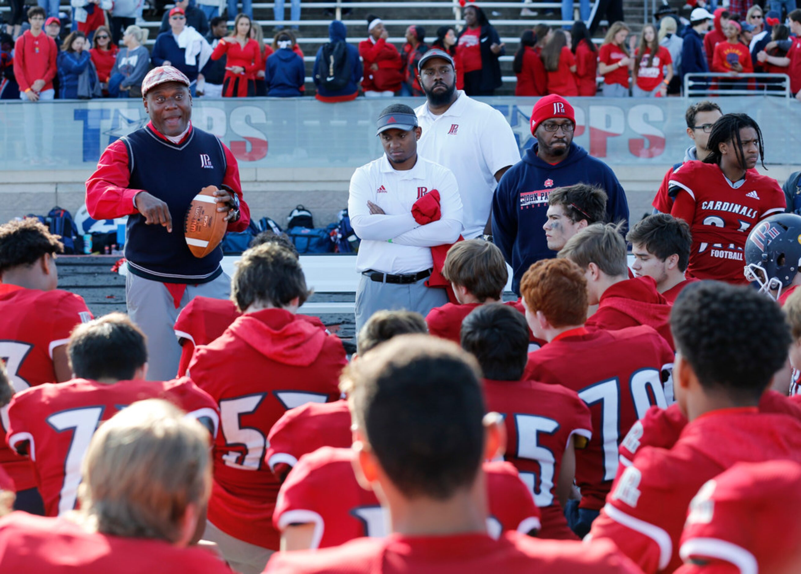 Plano John Paul II's head coach George Teague talks to his players after losing to Parish...