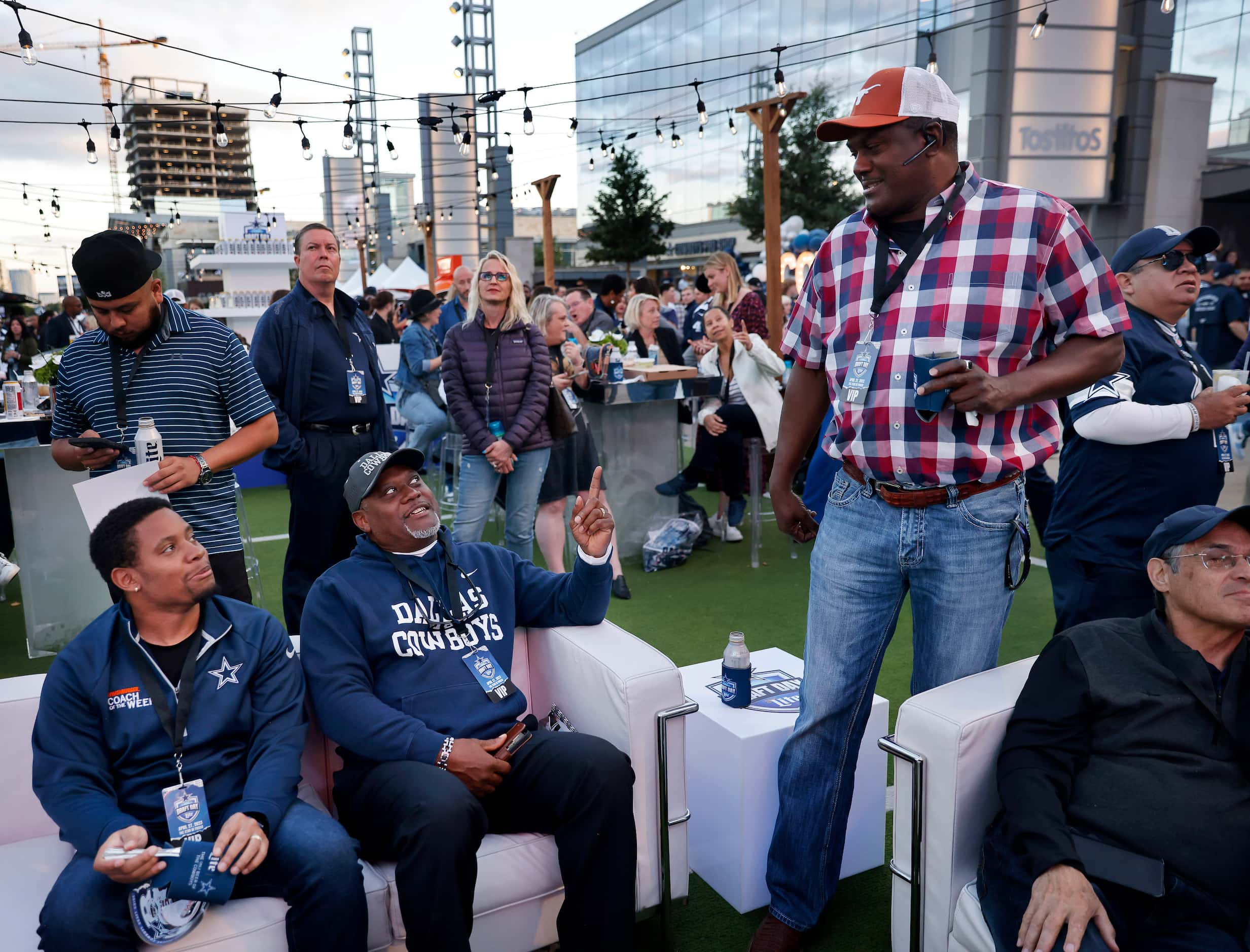 Former Dallas Cowboys football player George Teague (seated, center) and his son James...