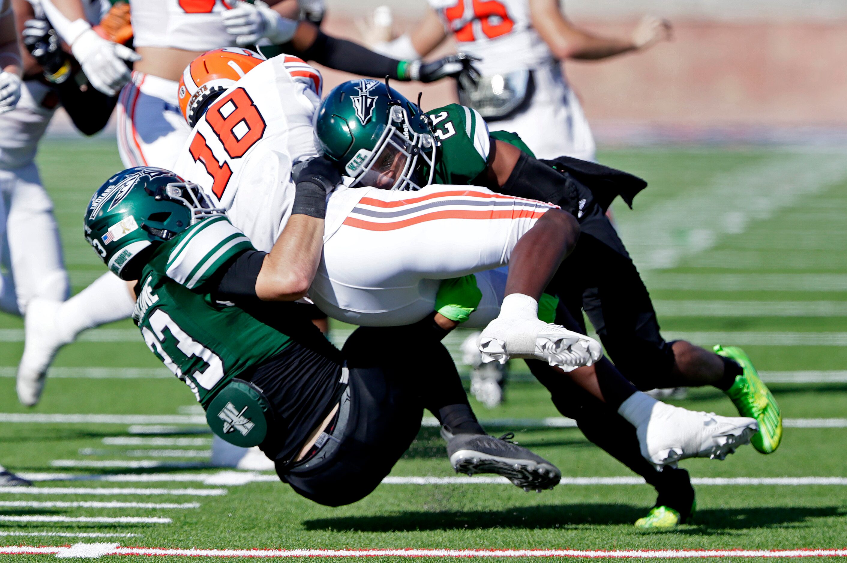 Waxahachie High School outside linebacker Noah Malone (33) and Waxahachie High School...