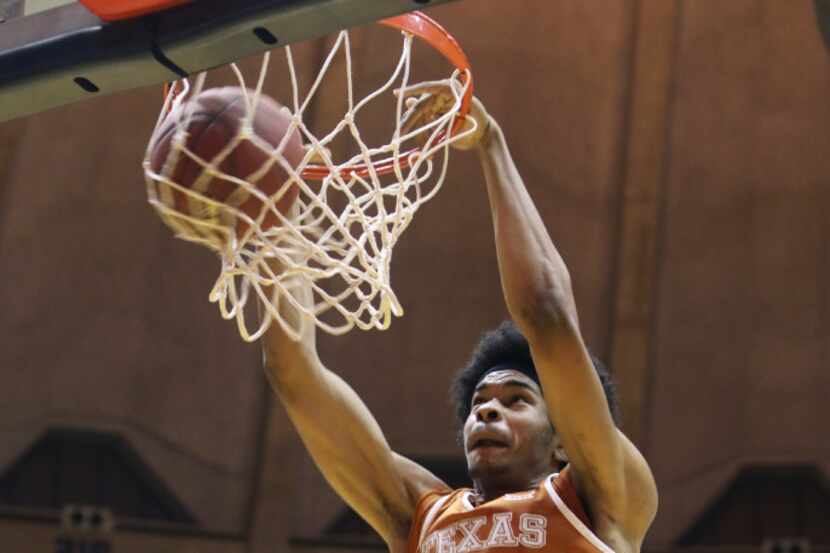 Texas forward Jarrett Allen (31) dunks the ball during the first half of an NCAA college...