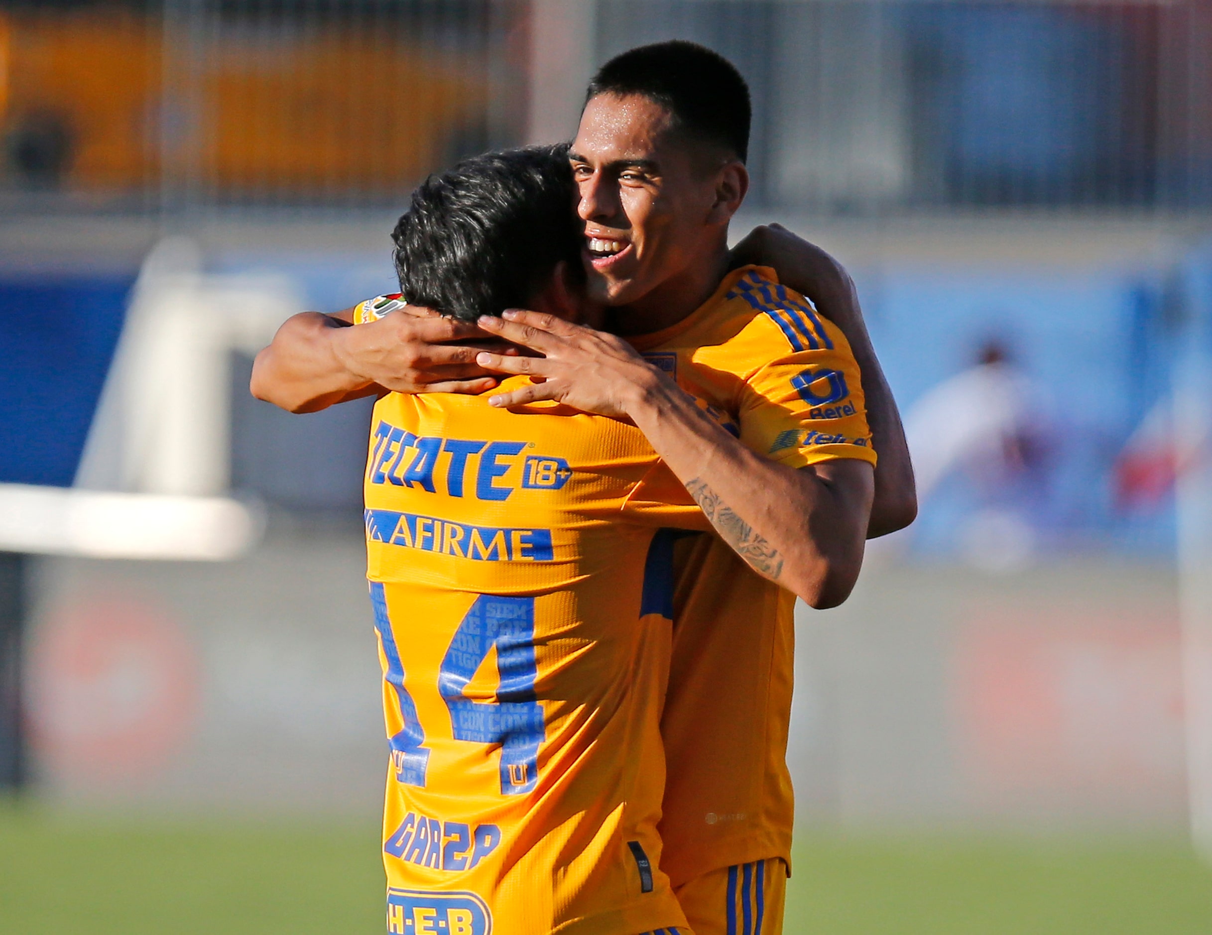 Tigres UANL defender Jesus Garza (14) is embraced by Tigres UANL midfielder David Ayala (18)...