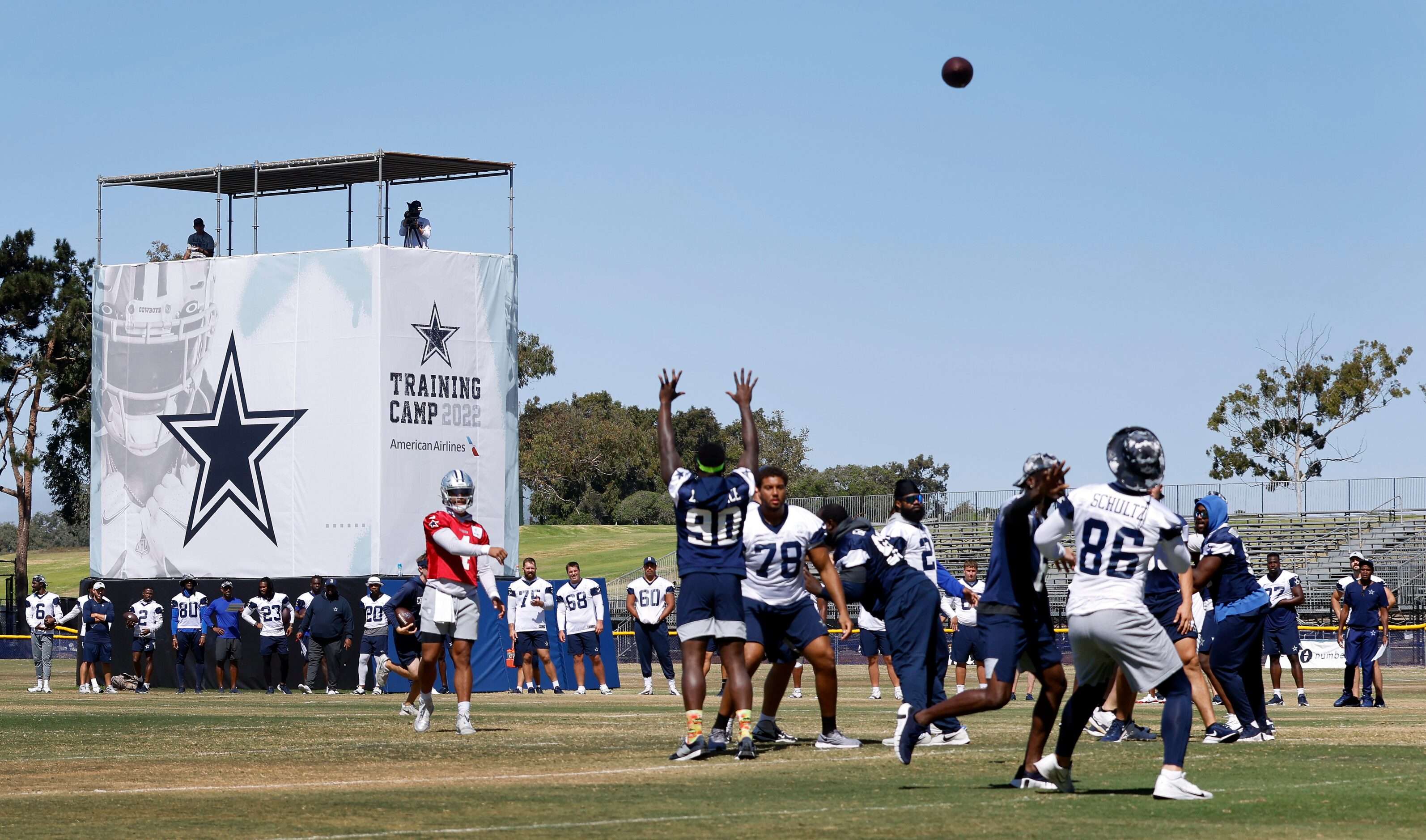 Dallas Cowboys quarterback Dak Prescott (4) tosses a pass to tight end Dalton Schultz (86)...