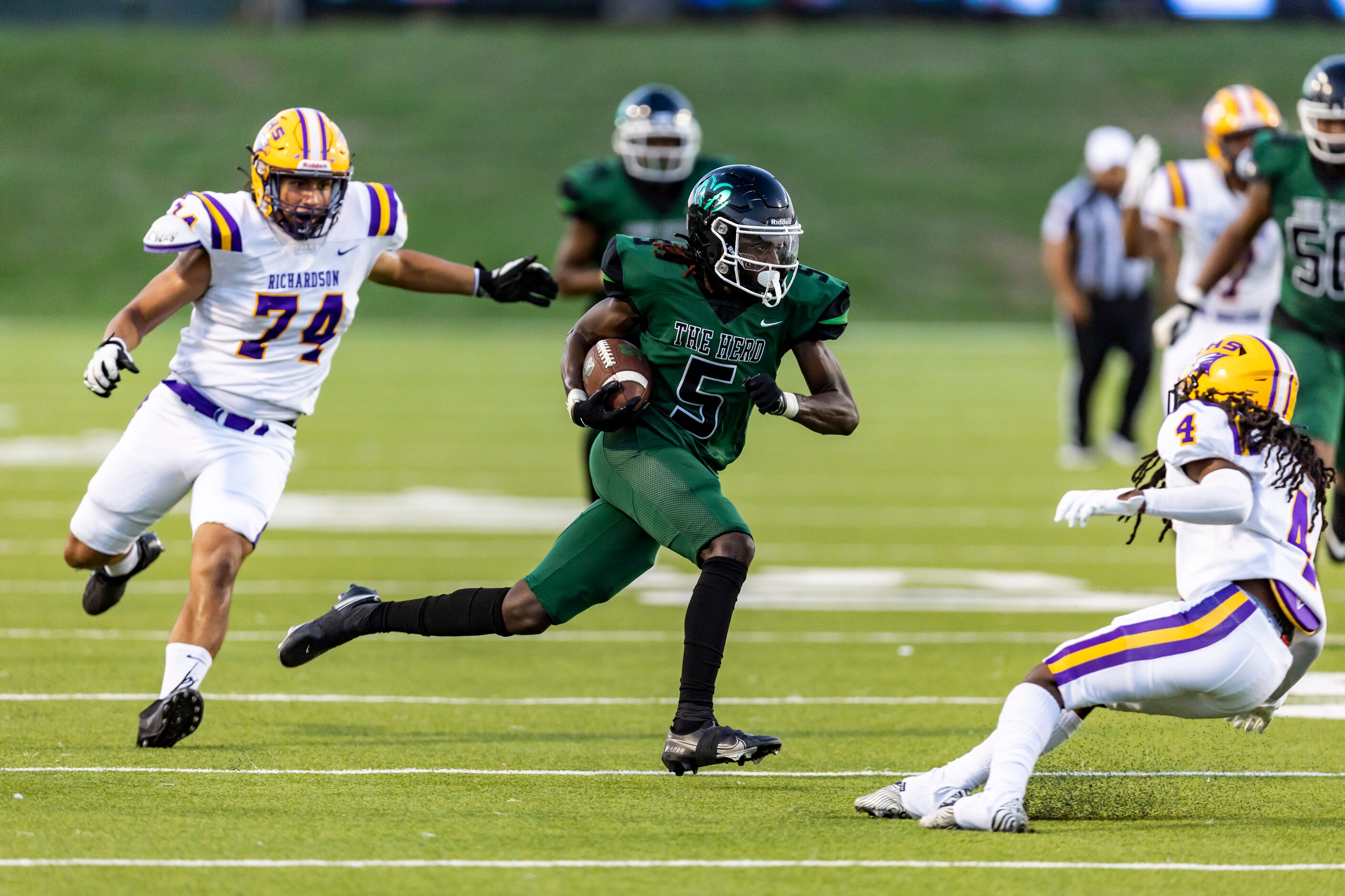 Berkner senior wide receiver Tre Randle (5) looks for room against Richardson junior...