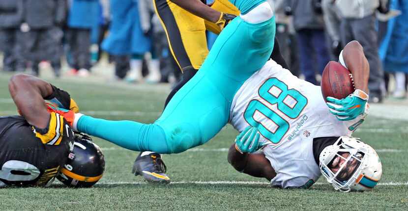 Miami Dolphins' Dion Sims lands after being tackled in the fourth quarter by Pittsburgh...