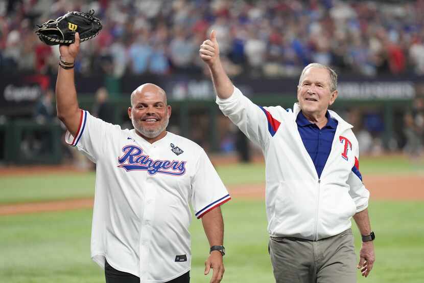 Former Texas Rangers catcher Iván “Pudge” Rodríguez and former President George W. Bush wave...