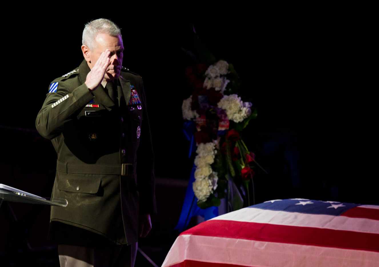 General John M. Murray of the U.S. Army salutes during a memorial service for Richard...
