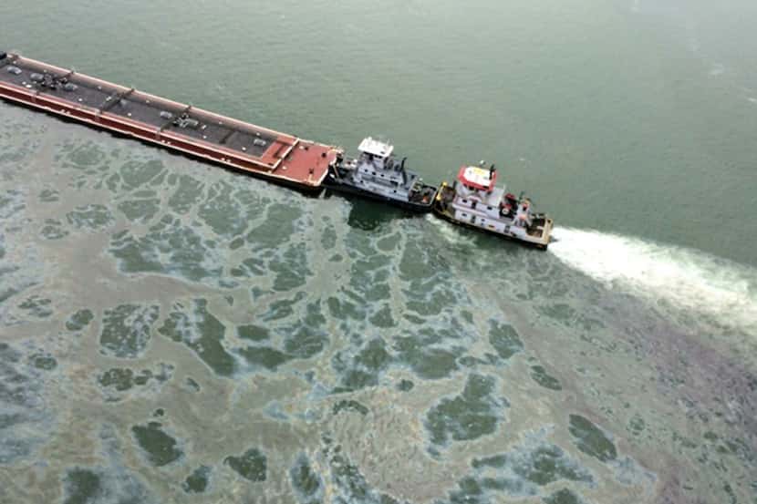 A barge loaded with marine fuel oil sat partially submerged in the Houston Ship Channel on...