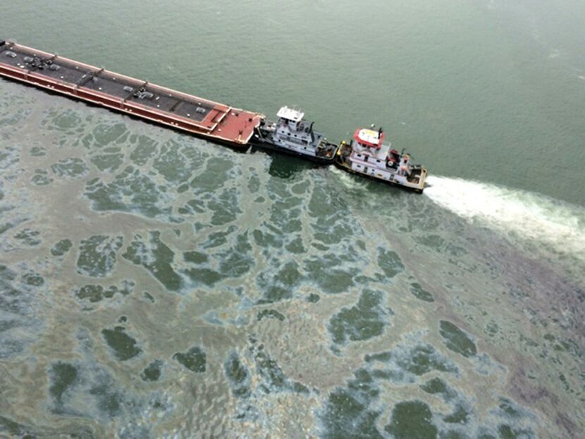 A barge loaded with marine fuel oil sat partially submerged in the Houston Ship Channel on...