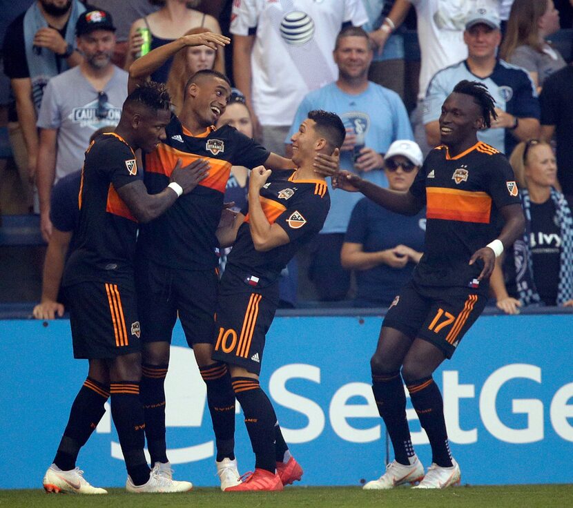 Houston Dynamo forward Mauro Manotas, second from left, celebrates his goal with teammates...