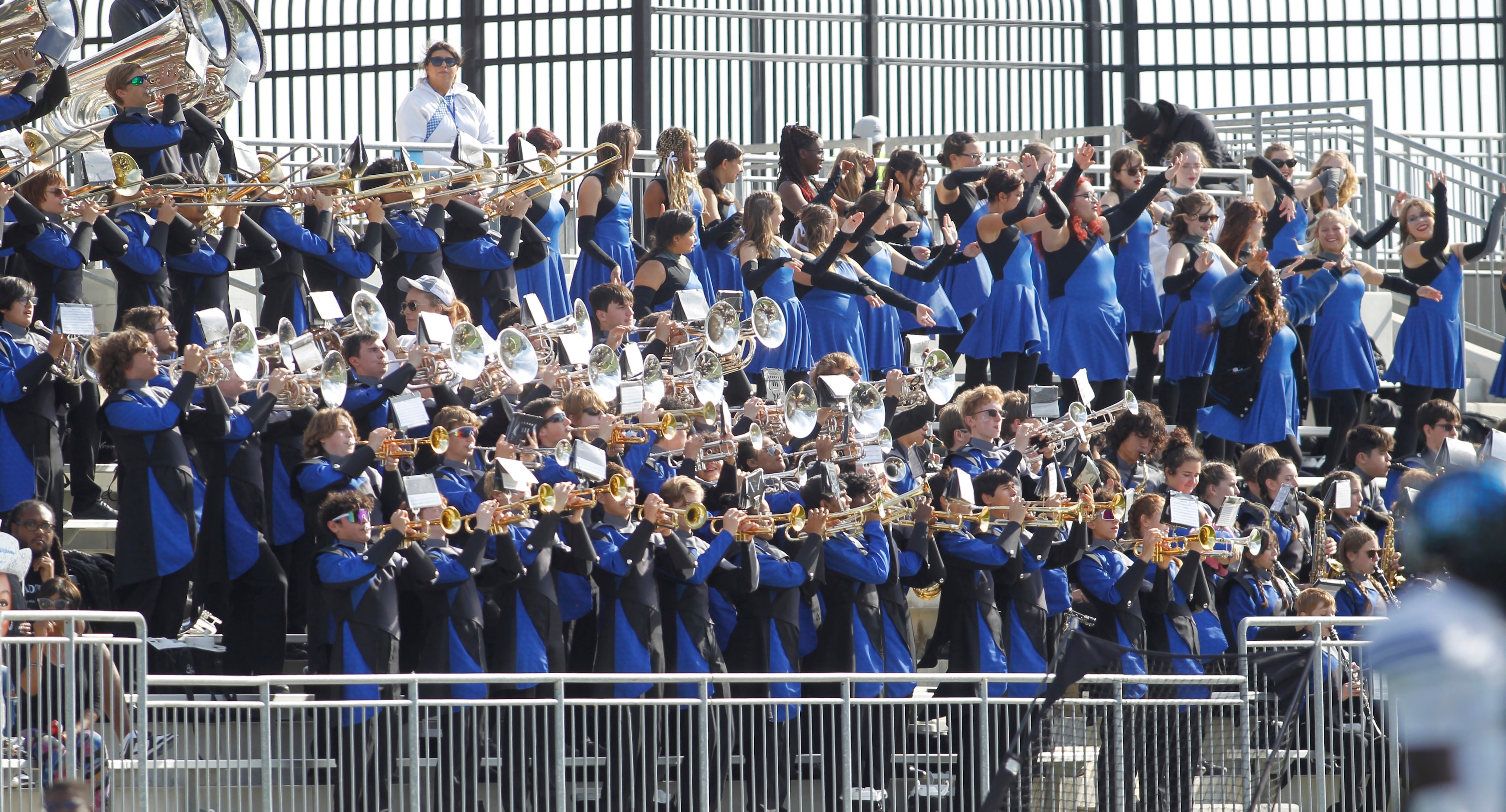 Members of the Byron Nelson band and drill team perform from the stands during the first...