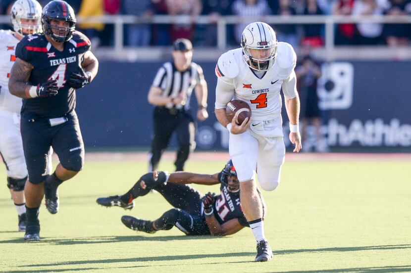 Oklahoma State quarterback J.W. Walsh of the Oklahoma State Cowboys breaks free for a...