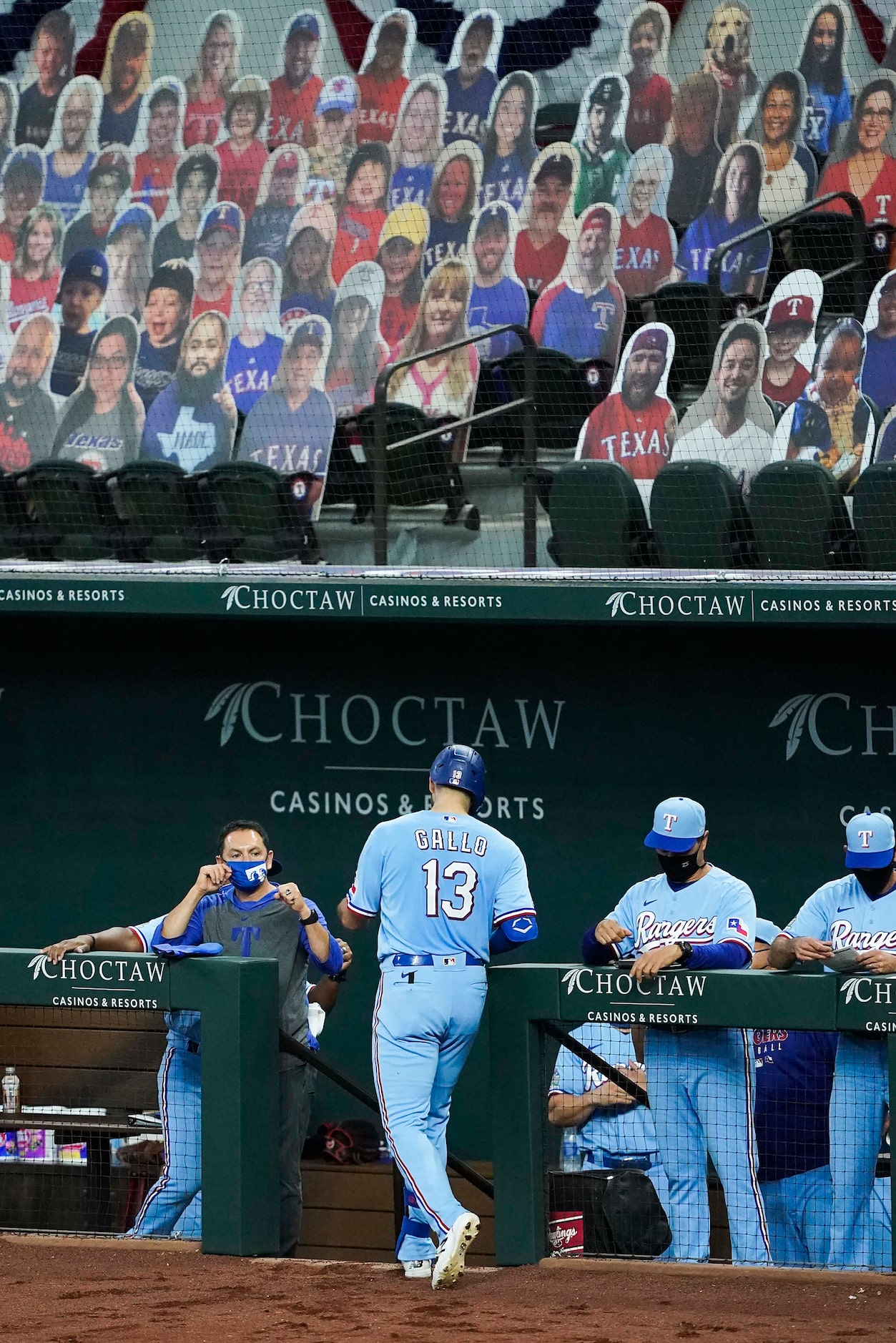 Texas Rangers outfielder Joey Gallo head to the dugout after hitting the first official home...