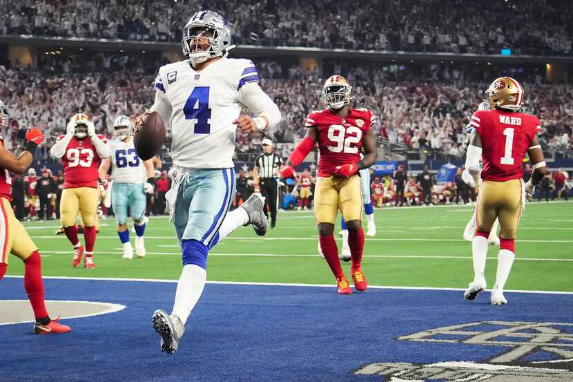 Dallas Cowboys quarterback Dak Prescott scores on a touchdown run during the second half of...