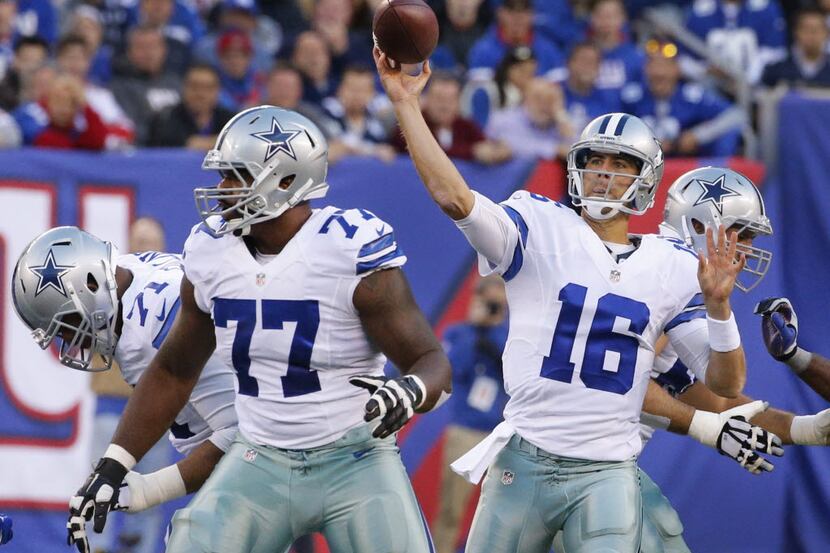 Dallas Cowboys quarterback Matt Cassel (16) throws a pass as tackle Tyron Smith (77) looks...