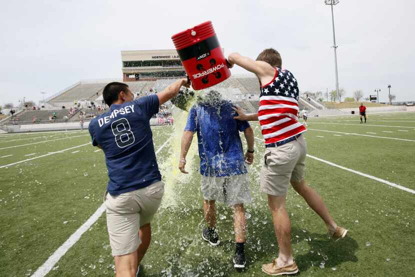 Eric Ramirez gets a Gatorade shower from seniors Joel Carlos (left) and Tyler Zych after a...