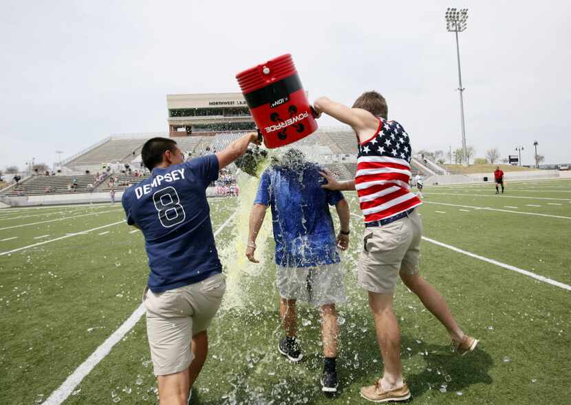 Eric Ramirez gets a Gatorade shower from seniors Joel Carlos (left) and Tyler Zych after a...