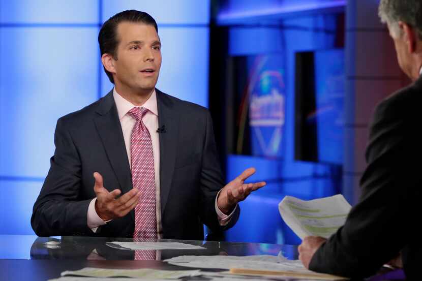 Donald Trump Jr., left, is interviewed by host Sean Hannity on his Fox News Channel...