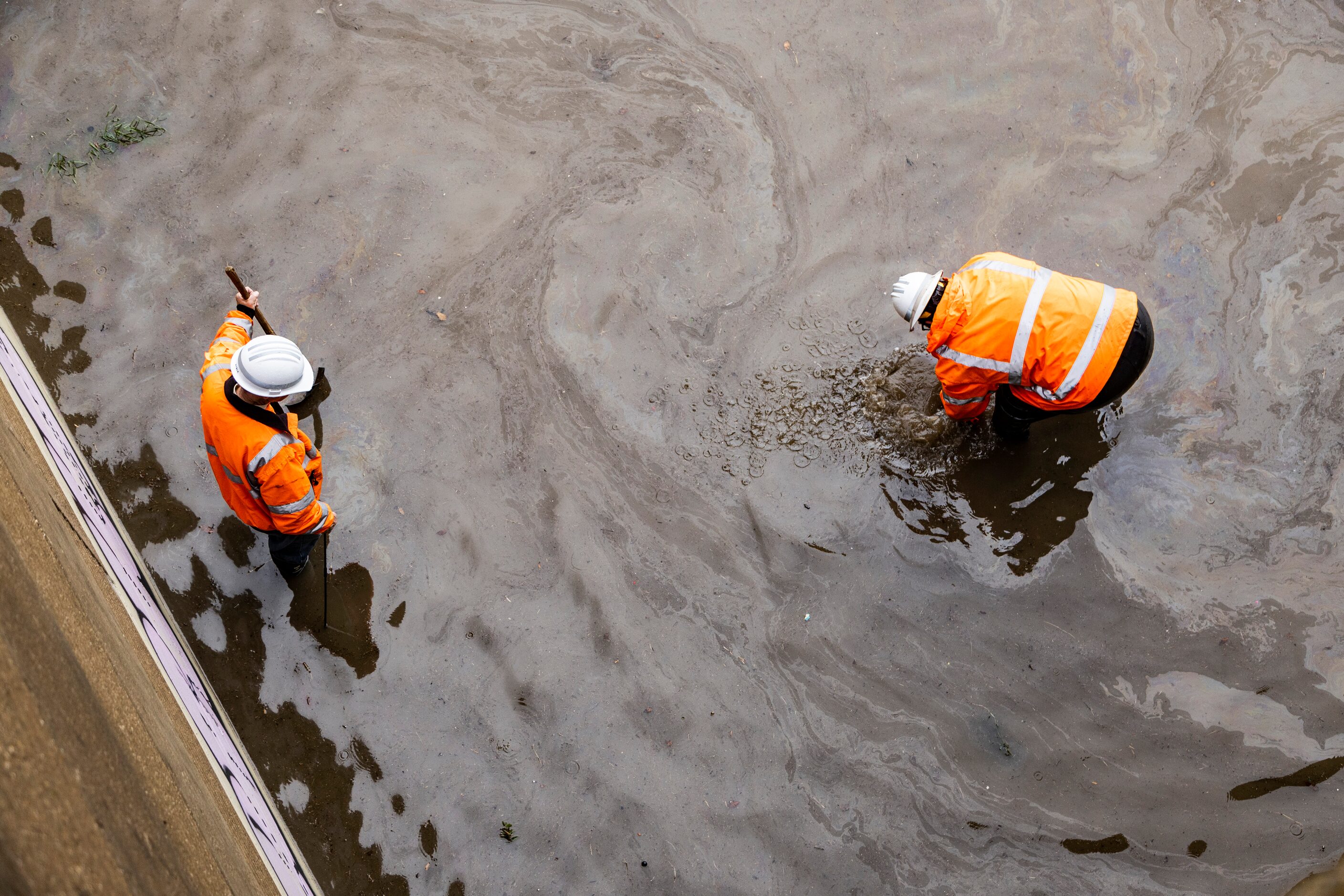 City workers attempt to unclog drains on the West bound I-30 to North bound Central...