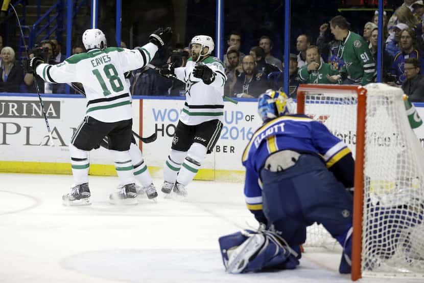 Dallas Stars' Vernon Fiddler, center, is congratulated by Patrick Eaves, left, after scoring...