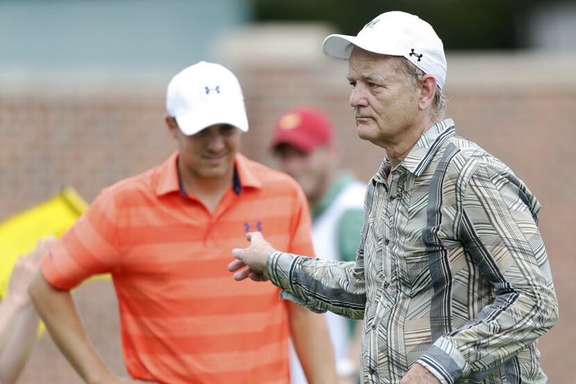 Actor Bill Murray points at Jordan Spieth after hitting a putt on the 16th hole during the...