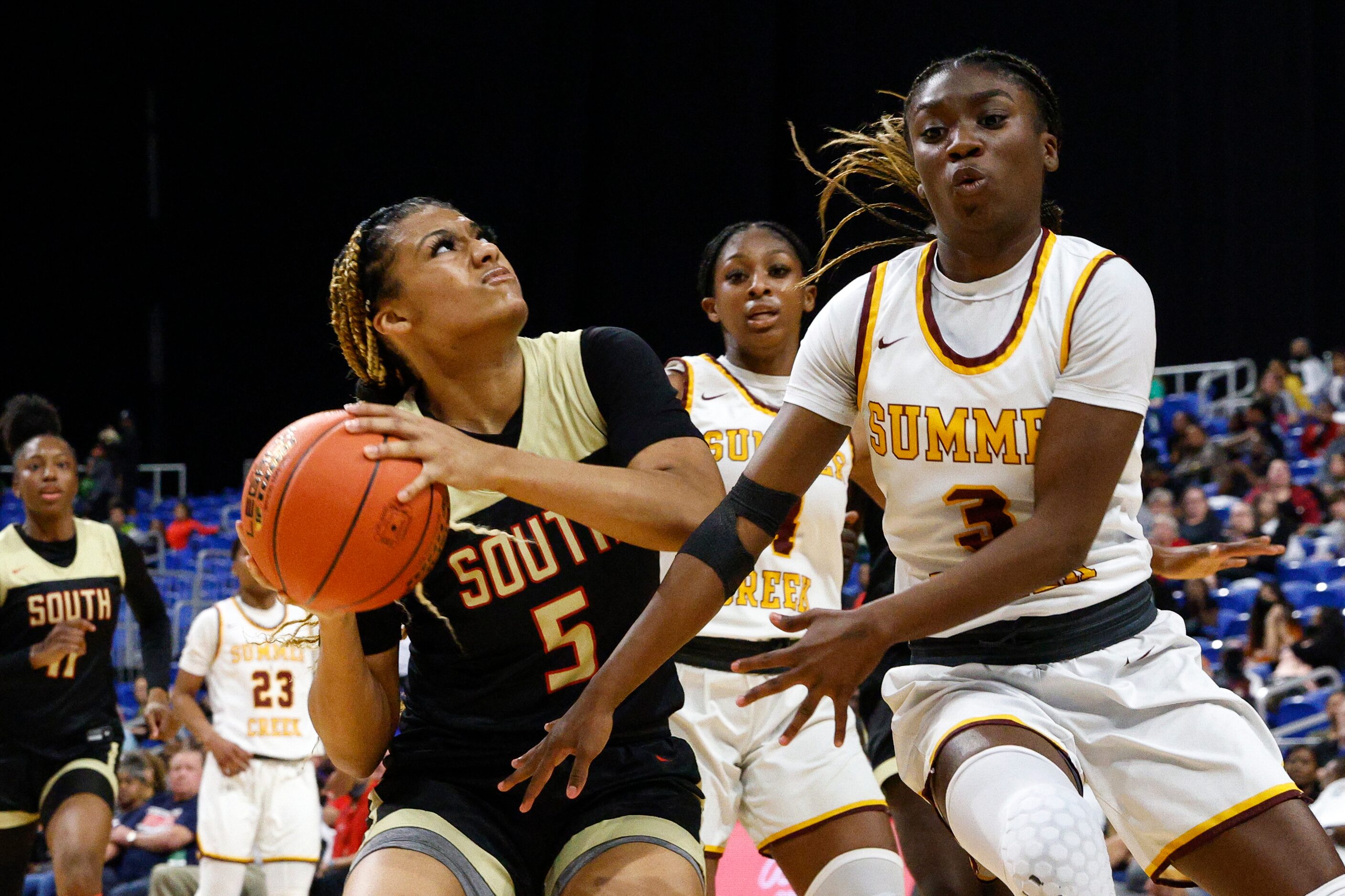 South Grand Prairie guard Jenny Handley (5) drives to the basket against a defending Humble...