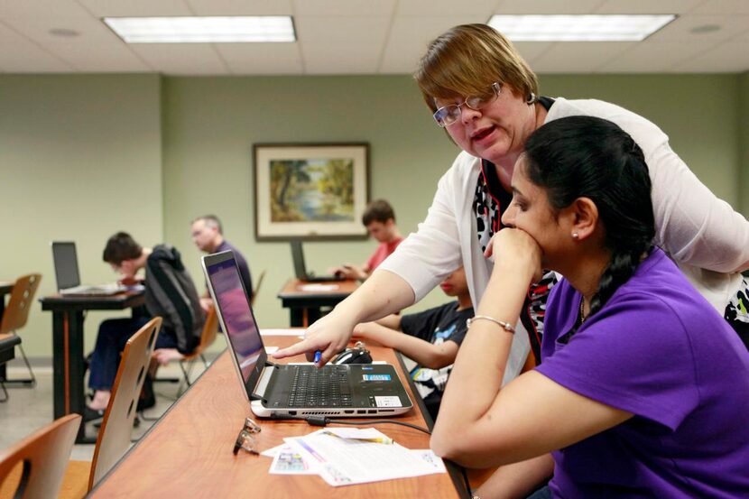 
Vrena Patrick (left), a communication services supervisor at the Richardson Public Library,...