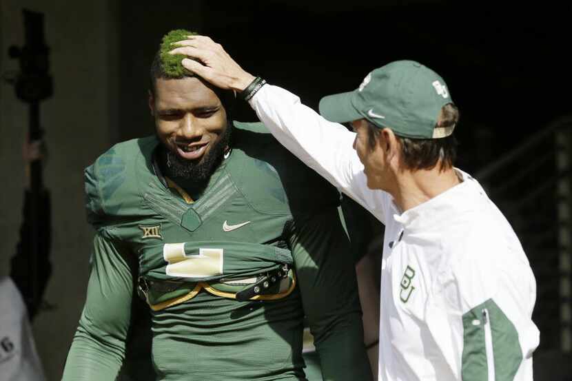 Baylor defensive end Shawn Oakman (2) gets a pat from head coach Art Briles before an NCAA...