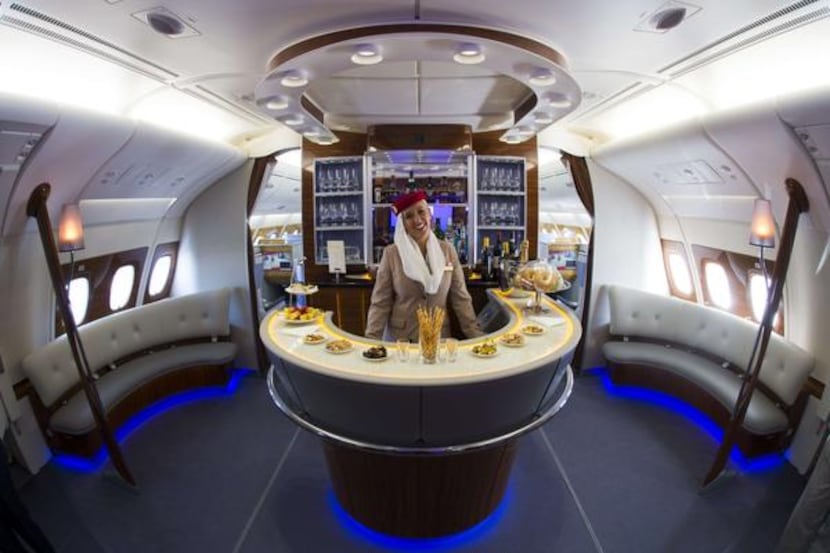 
A flight attendant  stands at the bar of the business class section of an Airbus A380....