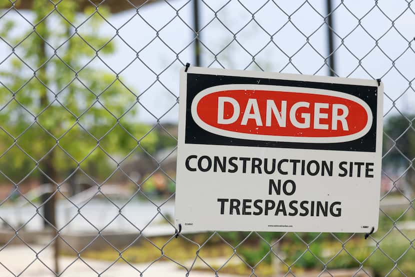 Signs remained on the fence at construction site of Harwood Park on June 14, 2023. Harwood...